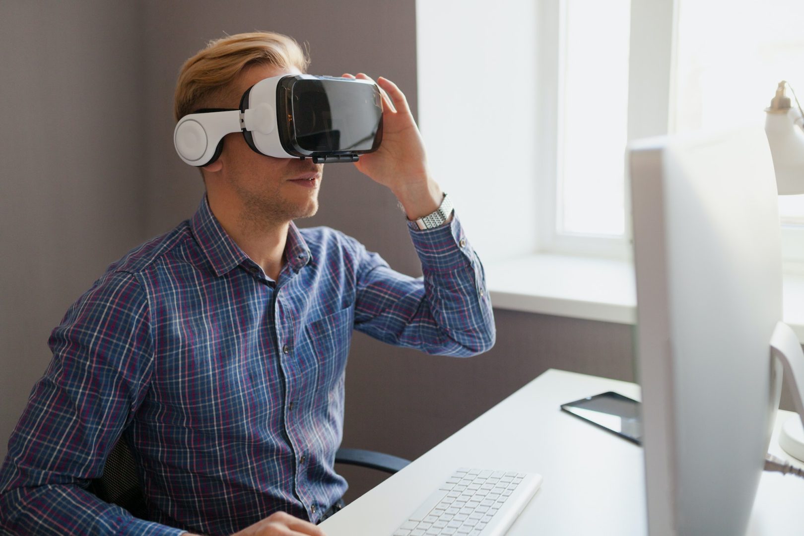 Man touching the VR headset